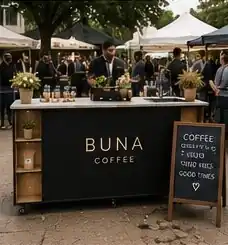 Black BUNA cart with a chalk menu board at a market